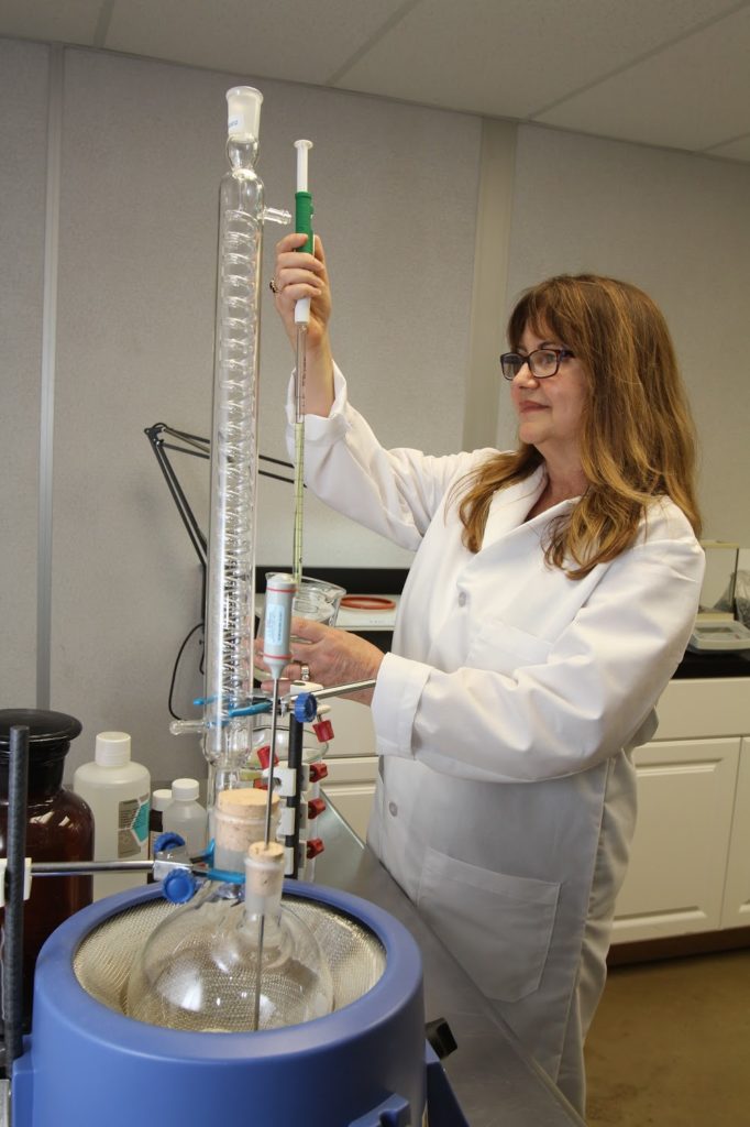Employee mixing a solution in laboratory